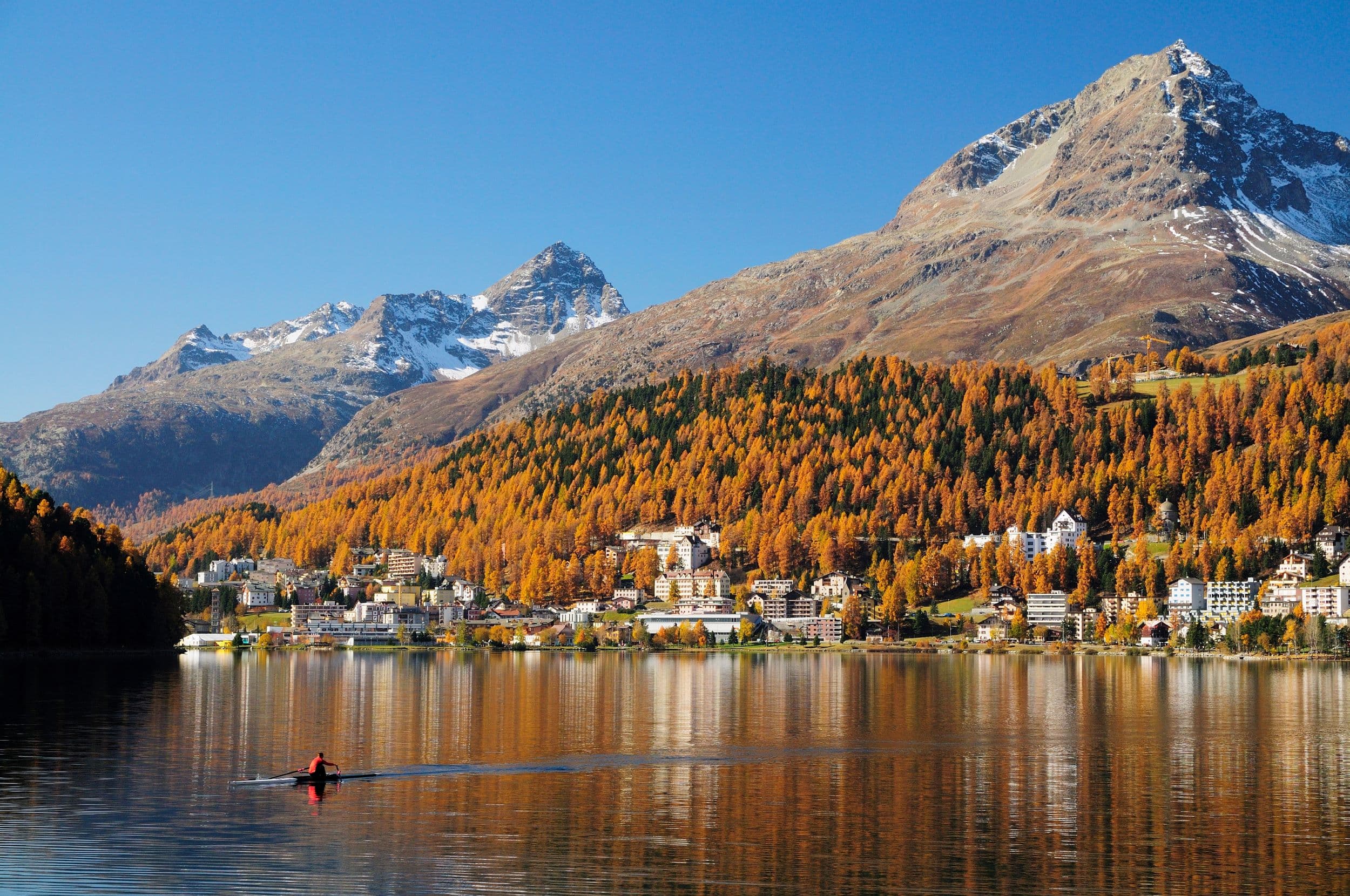 St Moritz lake in autumn with golden trees and mountain reflections on a Piz Bernina tour