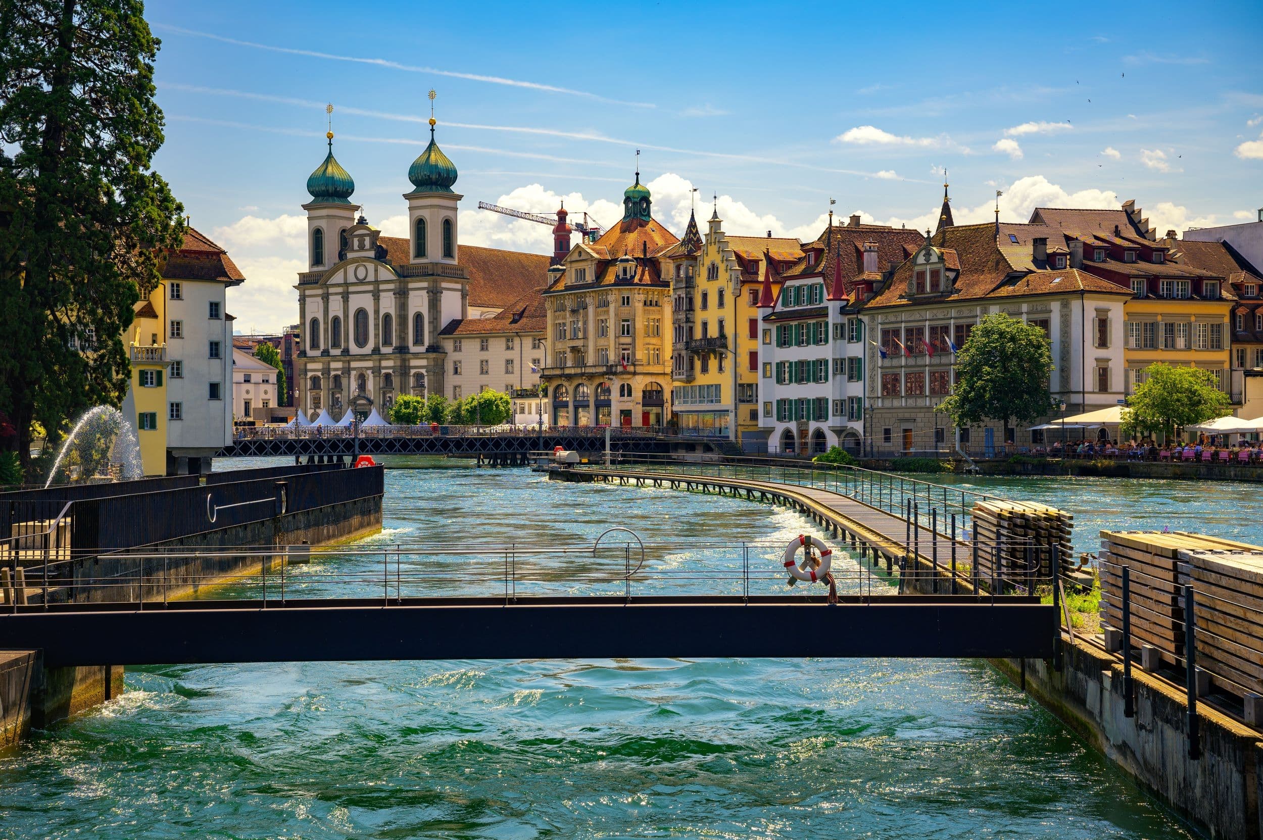 Reuss river weir and Jesuit Church in old town Lucerne Switzerland on a sunny summer day